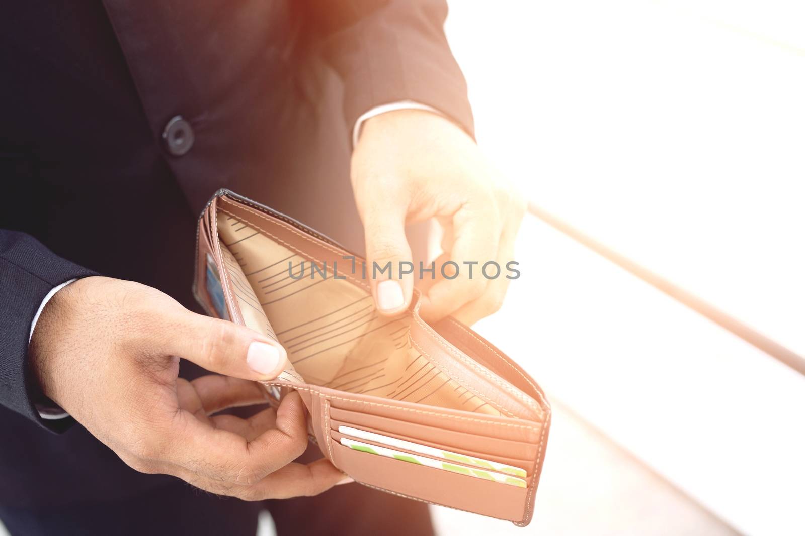 Empty wallet (no money) in the hands of an man. Cost control expenses poverty in concept