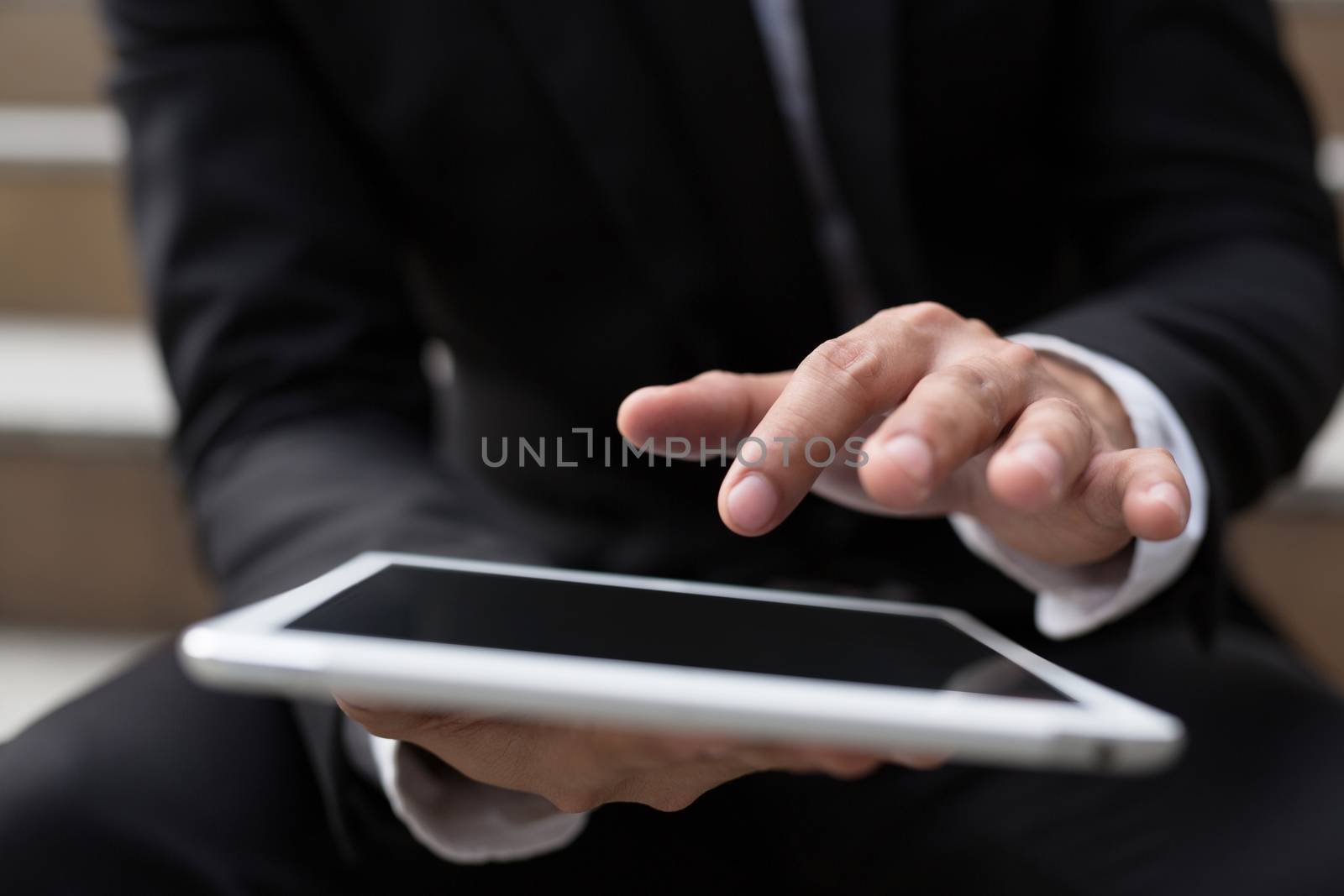 Young businessman using tablet adult working on a digital. by boytaro1428@gmail.com