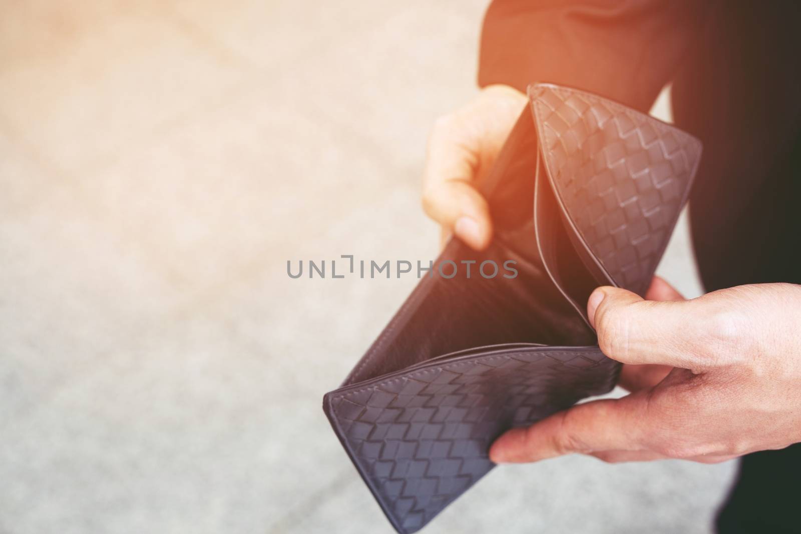 Unhappy bankrupt man with empty wallet . Young man shows her empty wallet. Bankruptcy