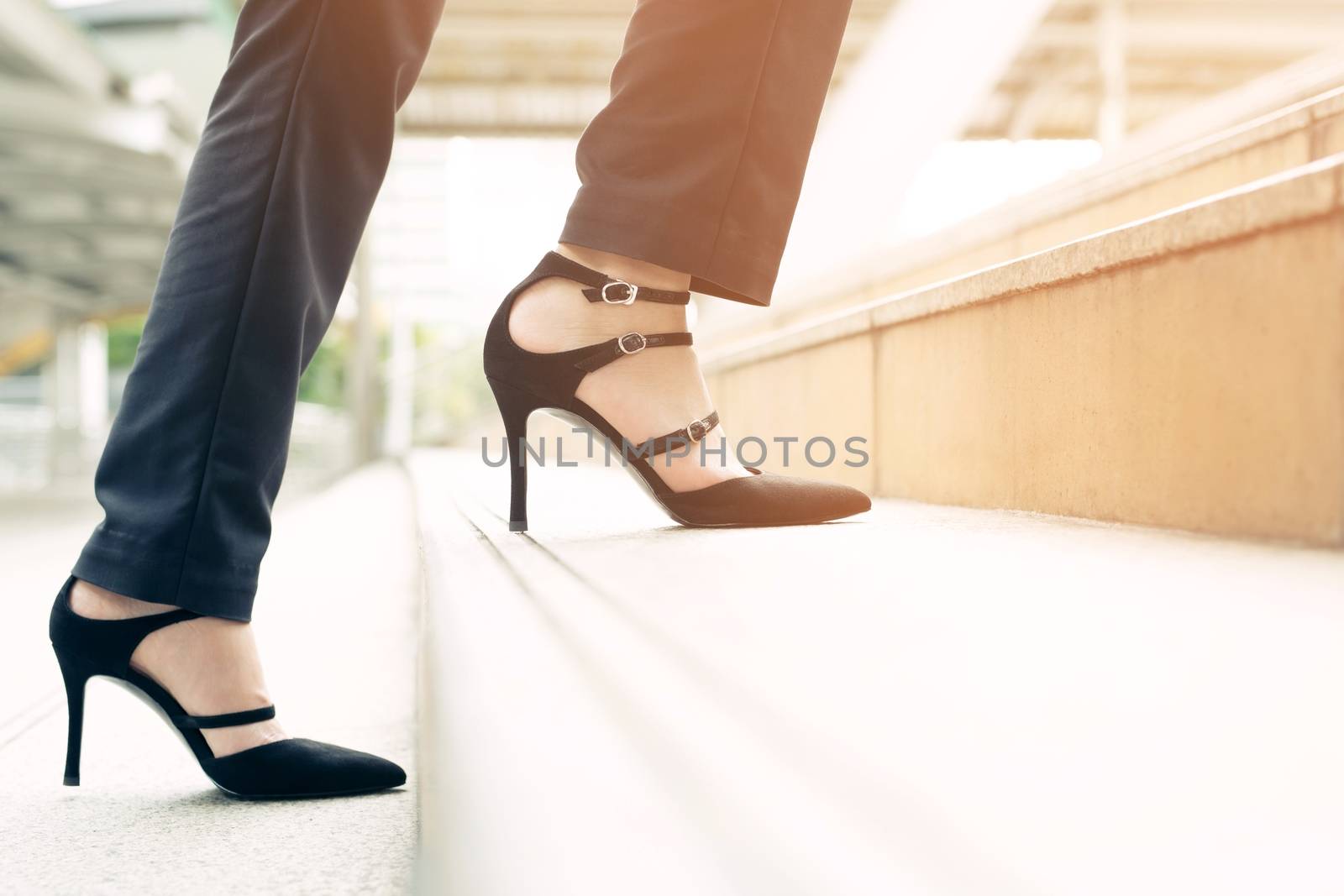 A business woman walking up the stairs to work at the office