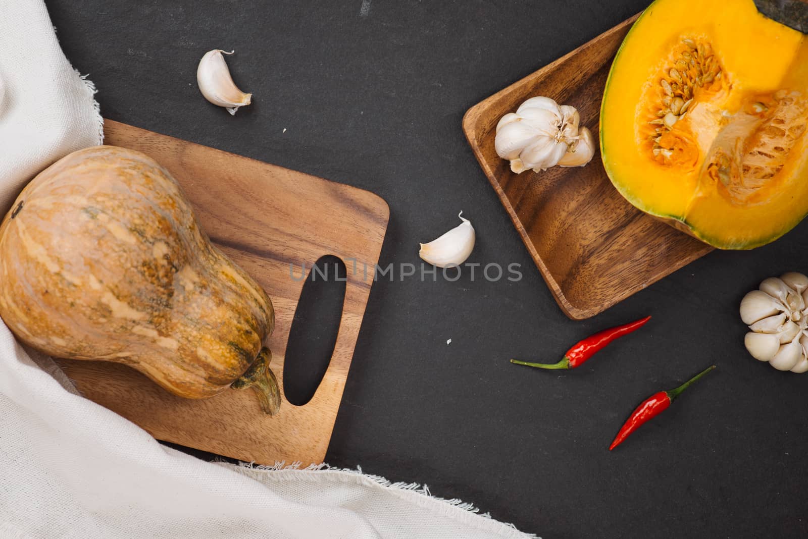 Delicious fresh pieces of ripe pumpkin on wooden background by makidotvn