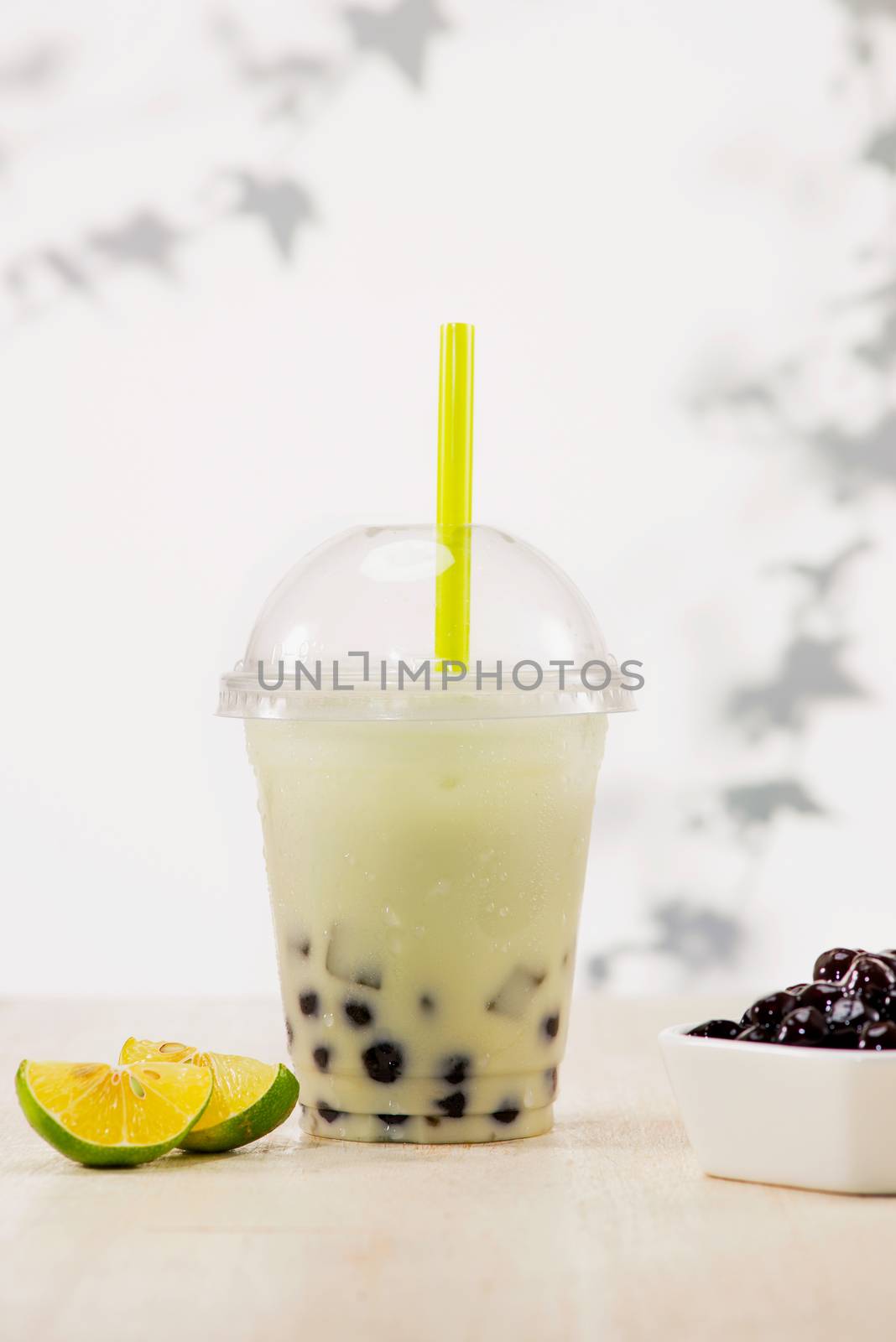 Lemon bubble boba tea with milk and tapioca pearls in plastic cu by makidotvn