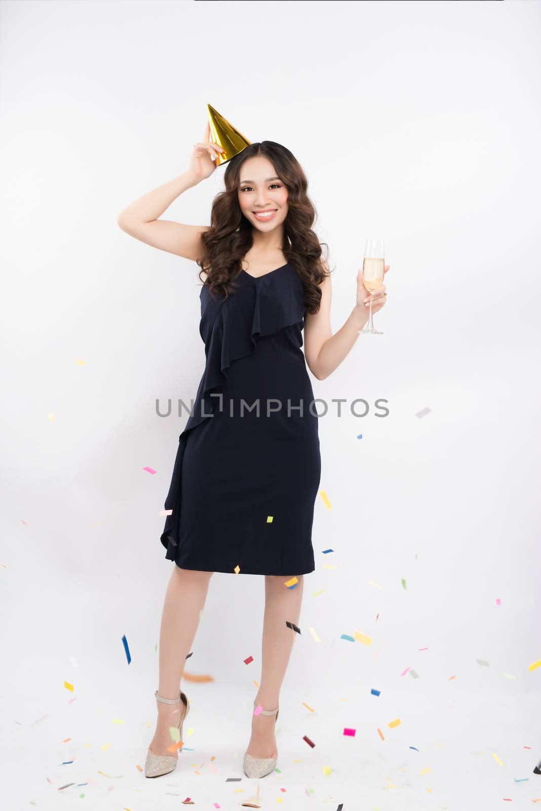 Full length of asian woman celebrating holding wine glass with c by makidotvn