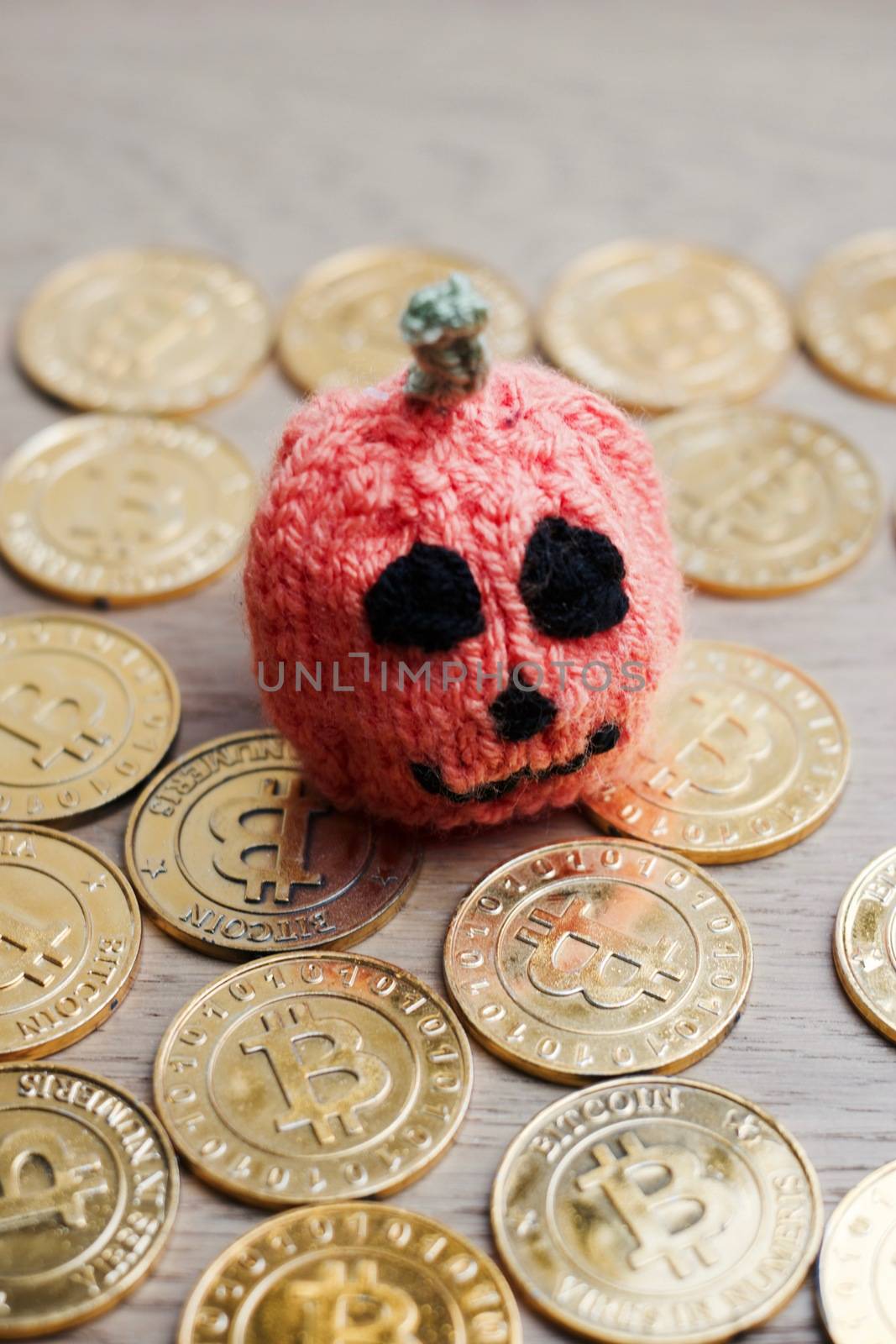 Digital currency physical metal bitcoin coin. Halloween pumpkin concept.
