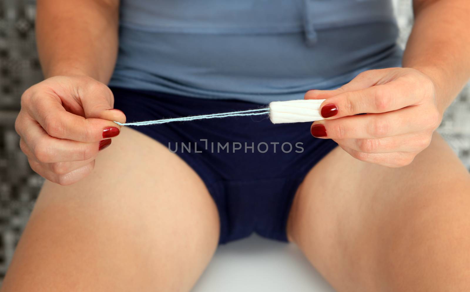 tampon in hand of woman for use at periods