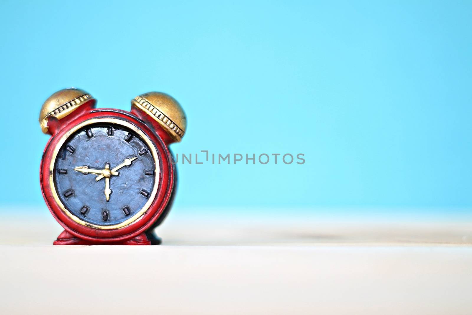 Business, finance, saving money and time concept : Miniature clock on desk table