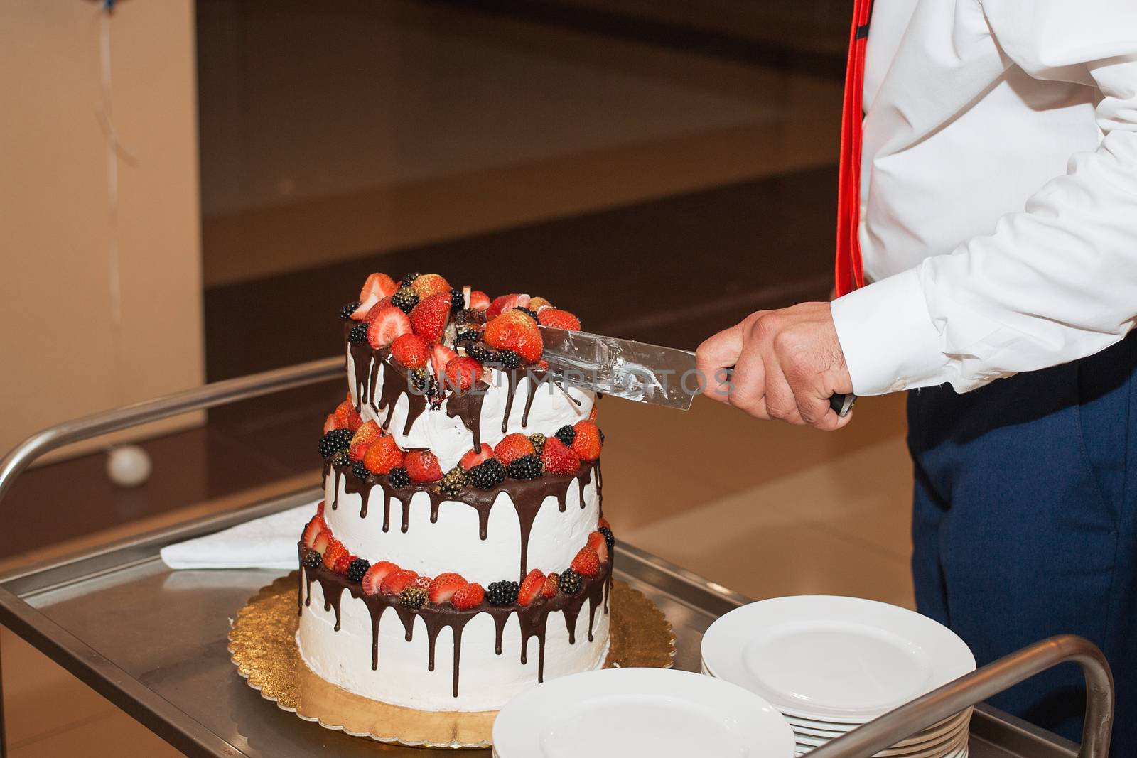 elegant pretty young bride and groom cut the wedding cake by 3KStudio