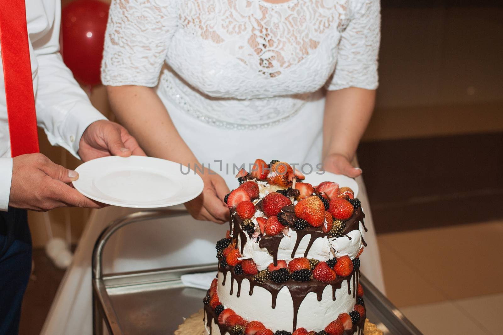 elegant pretty young bride and groom cut the wedding cake.