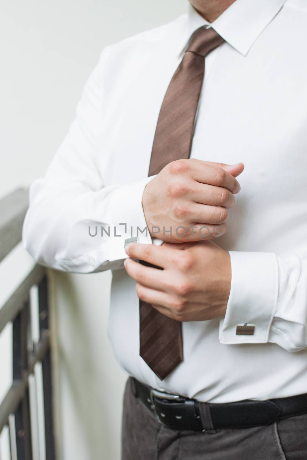 man buttons shirt, a man in a white shirt, morning groom, hands of a man close-up, a white shirt on a businessman, man buttons shirt sleeve, businessman puts on a suit