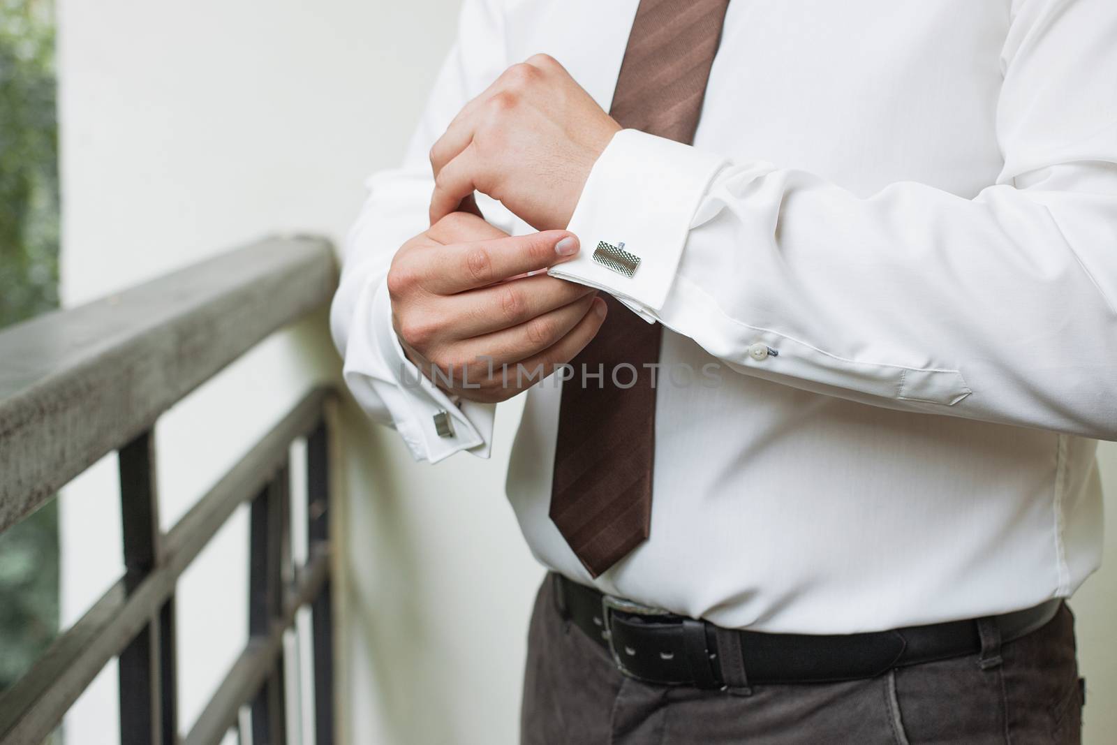 man buttons shirt, a man in a white shirt, morning groom, hands of a man close-up, a white shirt on a businessman, man buttons shirt sleeve, businessman puts on a suit