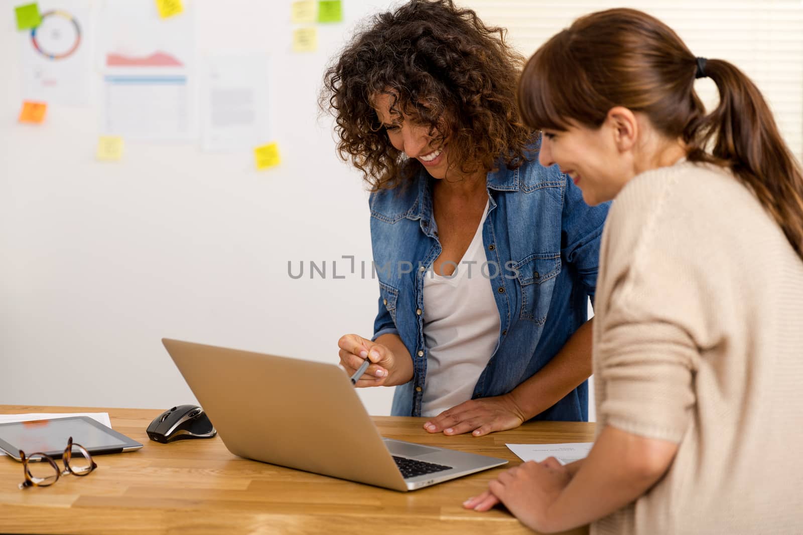 Shot of two businesswoman working together in an office