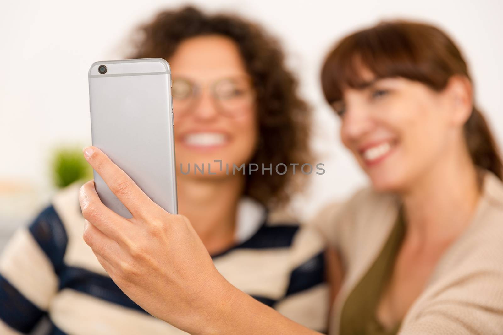 Two beautiful firends at home making  a selfie