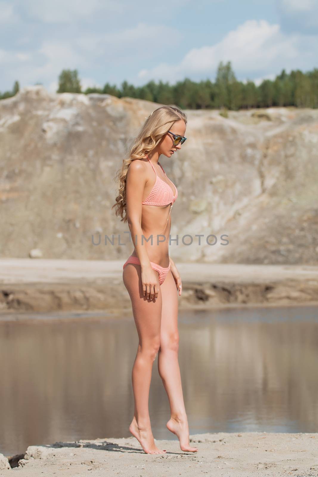 Girl on the sandy beach in a bathing suit by 3KStudio