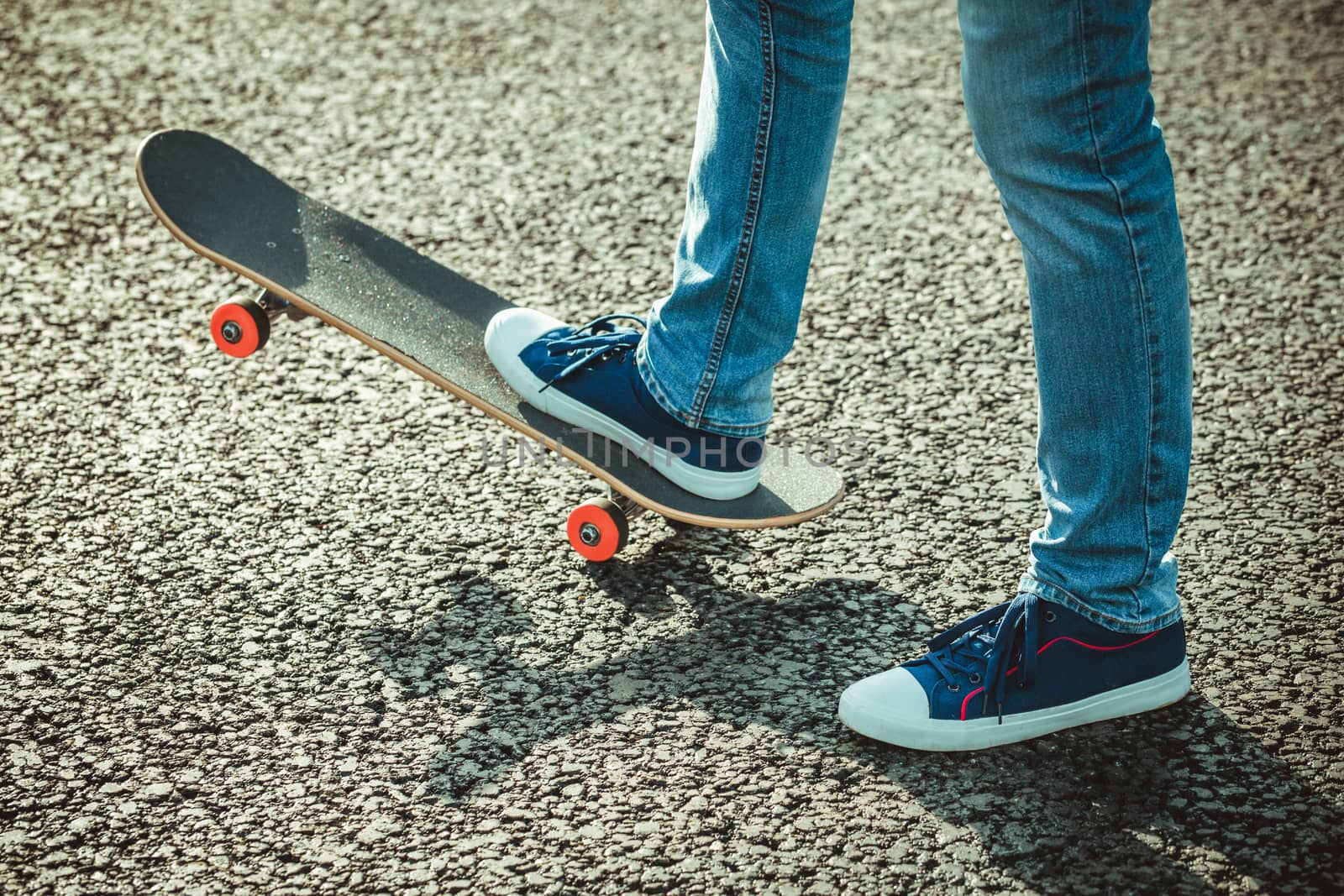 male feet in blue trainers and skateboard close up by boys1983@mail.ru