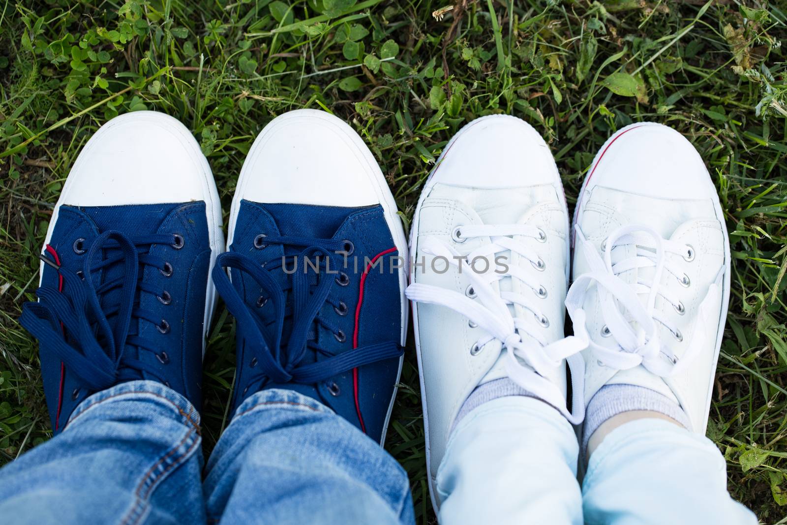 Close up of male and female's feet in sneakers