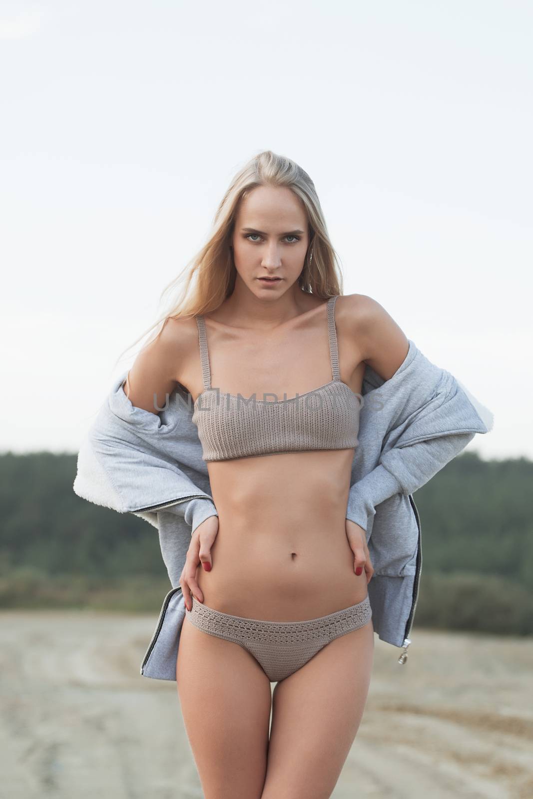 Girl on the sandy beach in a bathing suit.