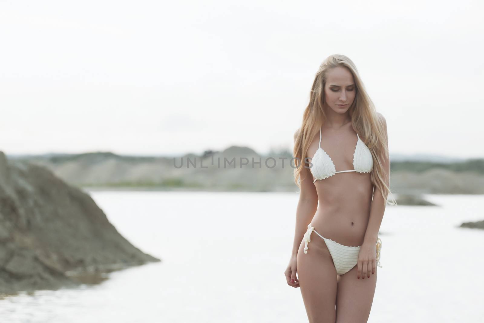 Girl on the sandy beach in a bathing suit by 3KStudio