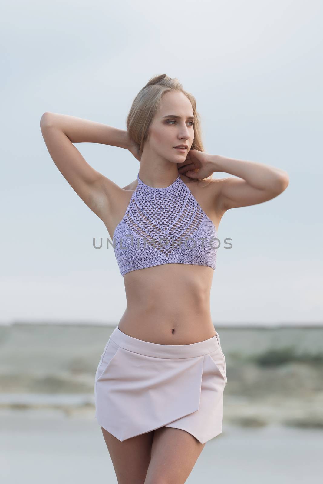 Girl on the sandy beach in a bathing suit.