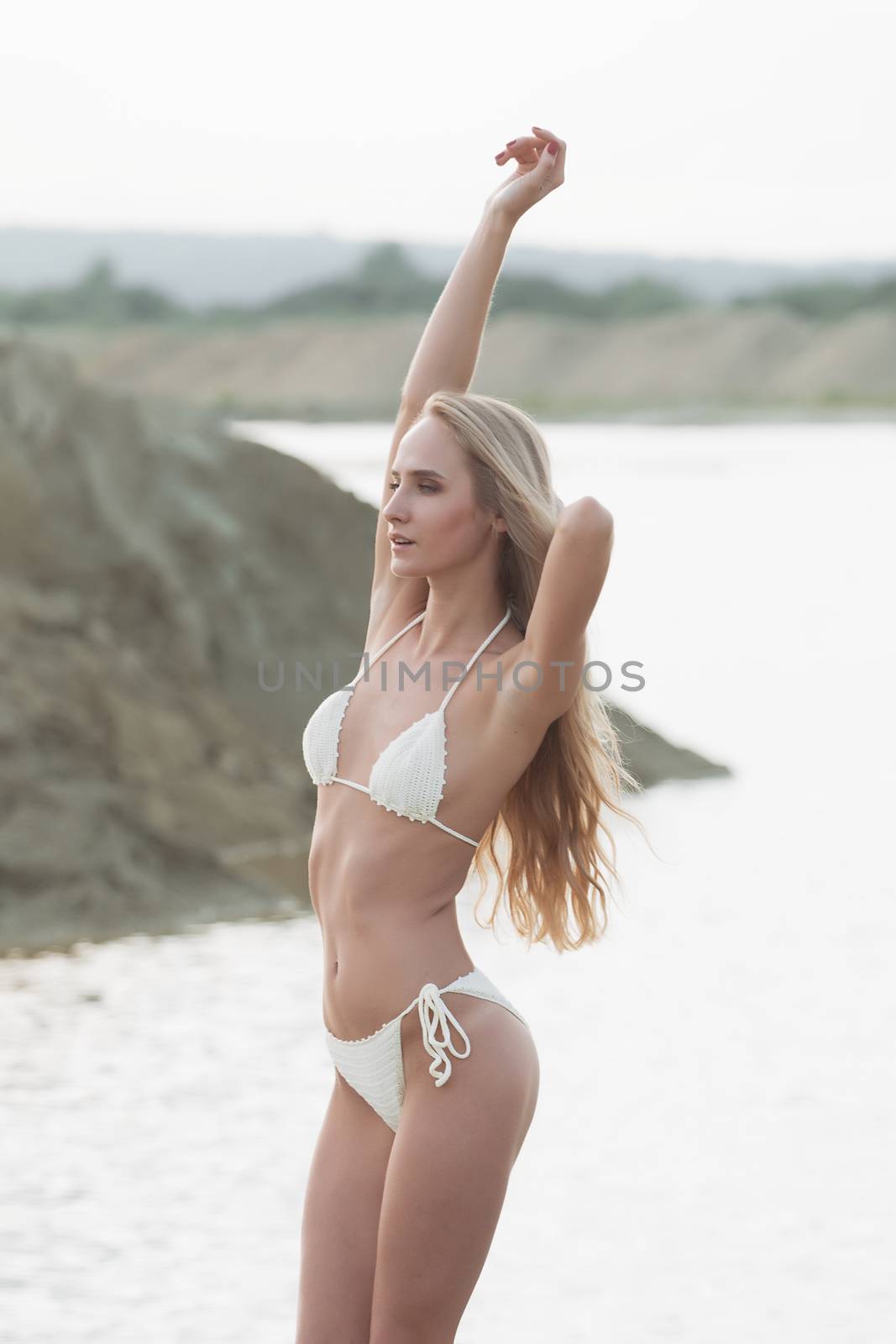 Girl in swimsuit at the sea. High fashion look.glamor beautiful sexy stylish blond. Caucasian young woman model.