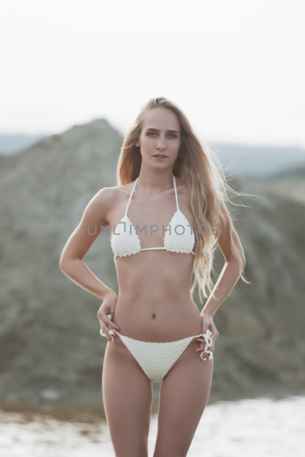 Girl in swimsuit at the sea. High fashion look.glamor beautiful sexy stylish blond. Caucasian young woman model.