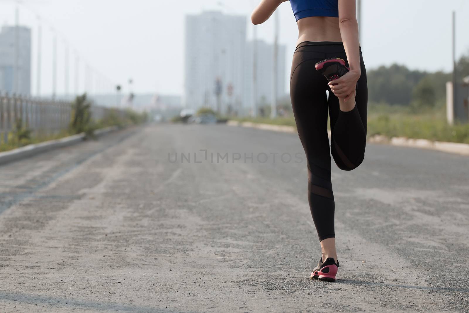 Young adult woman performs breathing exercise. Girl goes in for sports. Close up.
