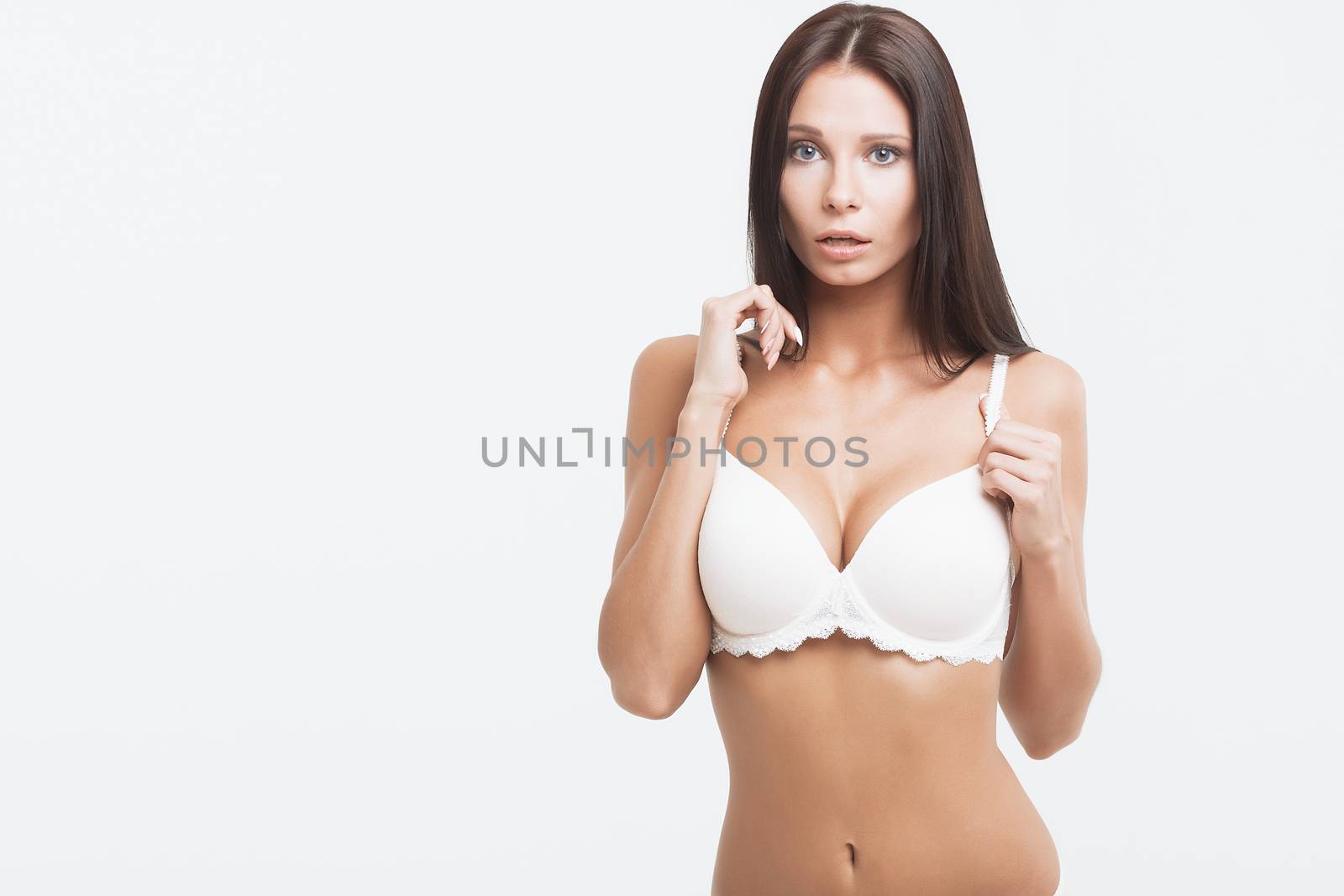 Perfect body young woman on a white background in sexy lingerie.