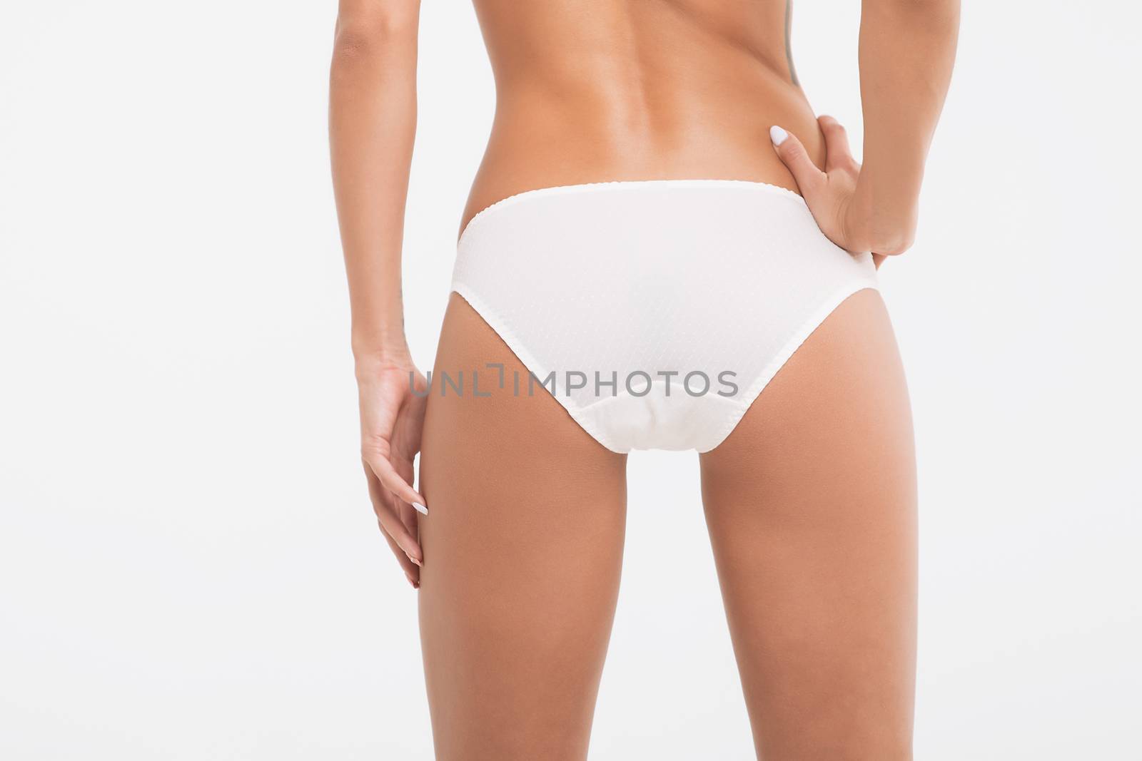 Perfect body young woman on a white background in sexy lingerie by 3KStudio