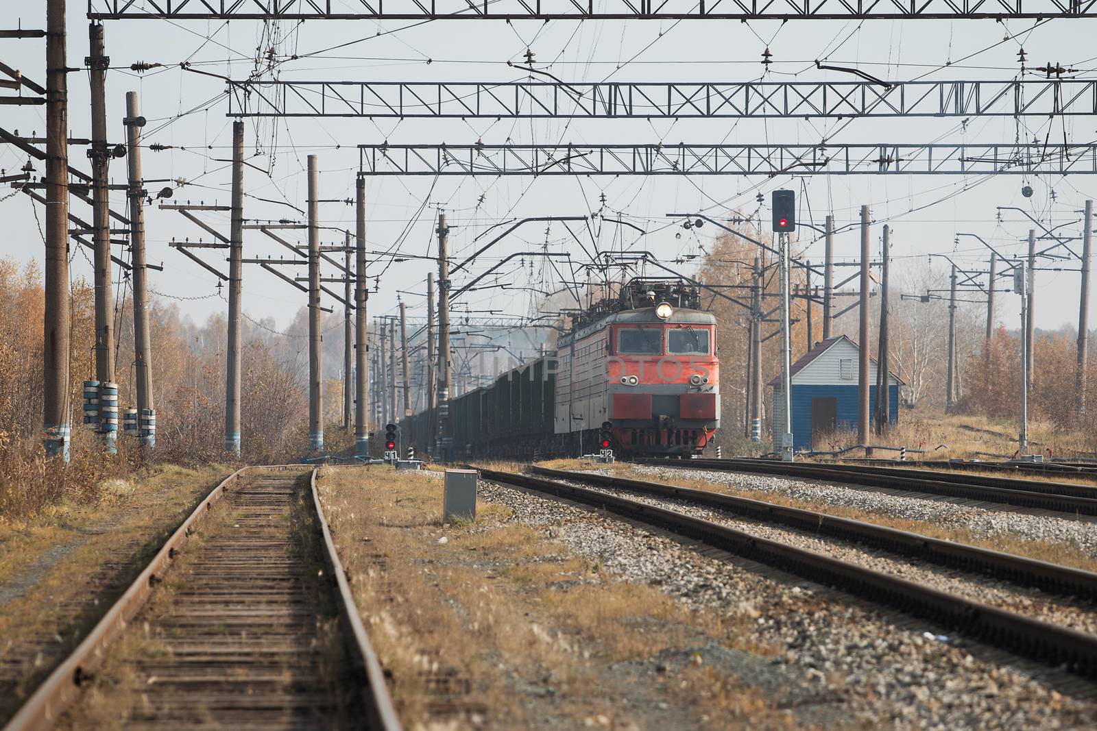 Freight train locomotive carrying with cargo on daylight.