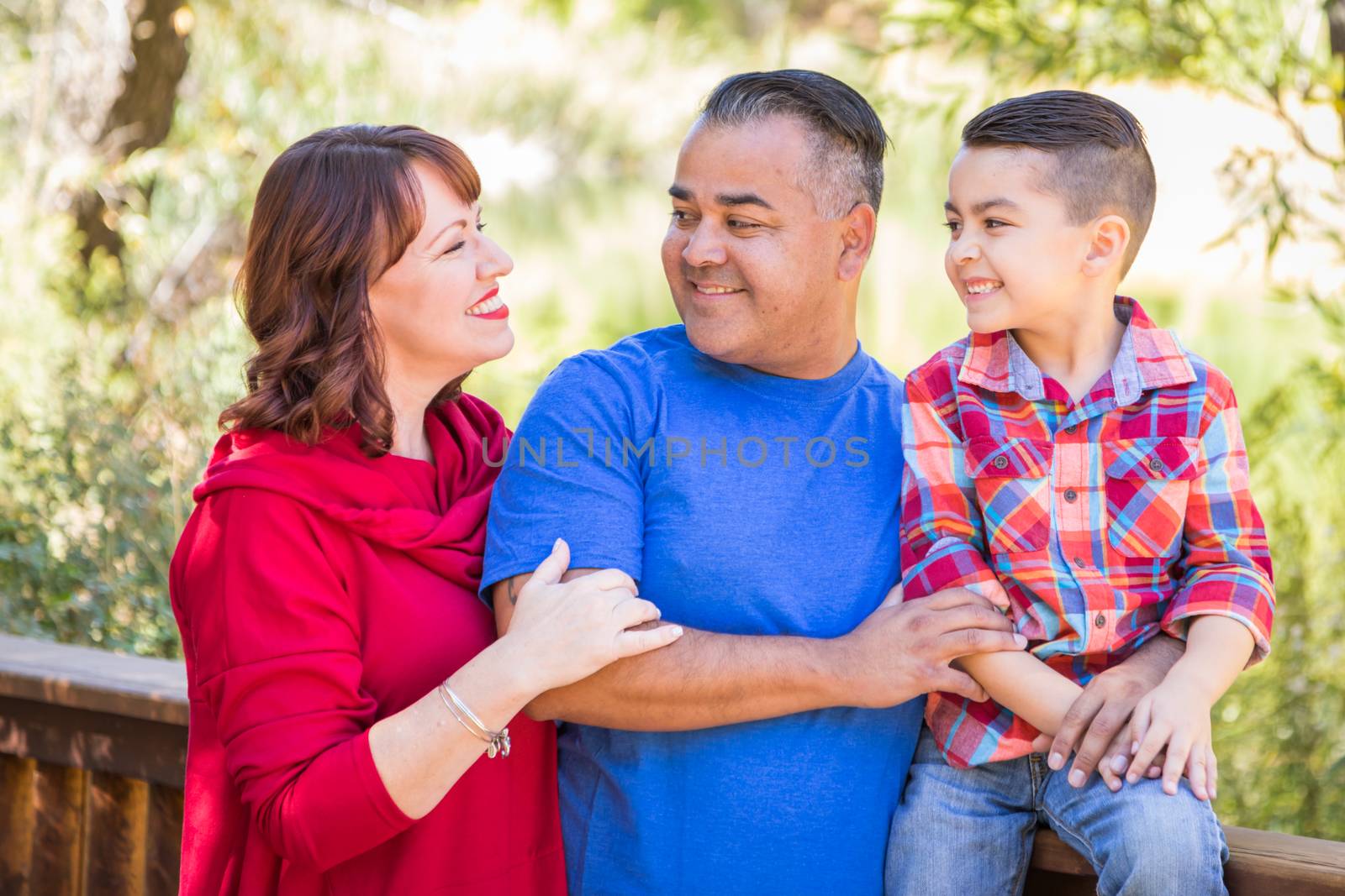 Mixed Race Caucasian and Hispanic Family At The Park. by Feverpitched