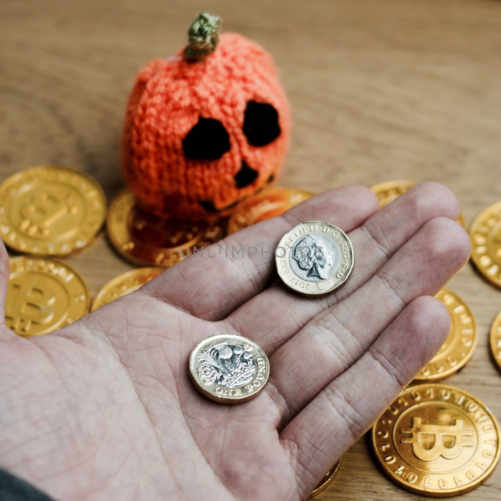 Digital currency physical metal bitcoin coin. Halloween pumpkin concept.