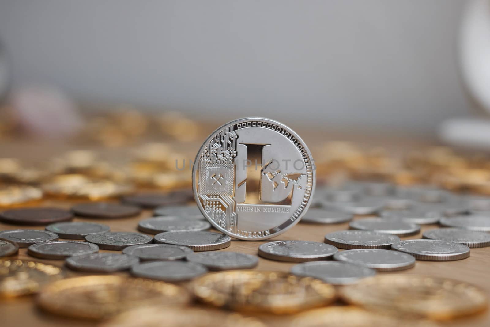 Digital currency physical metal litecoin coin. Cryptocurrency mining concept.