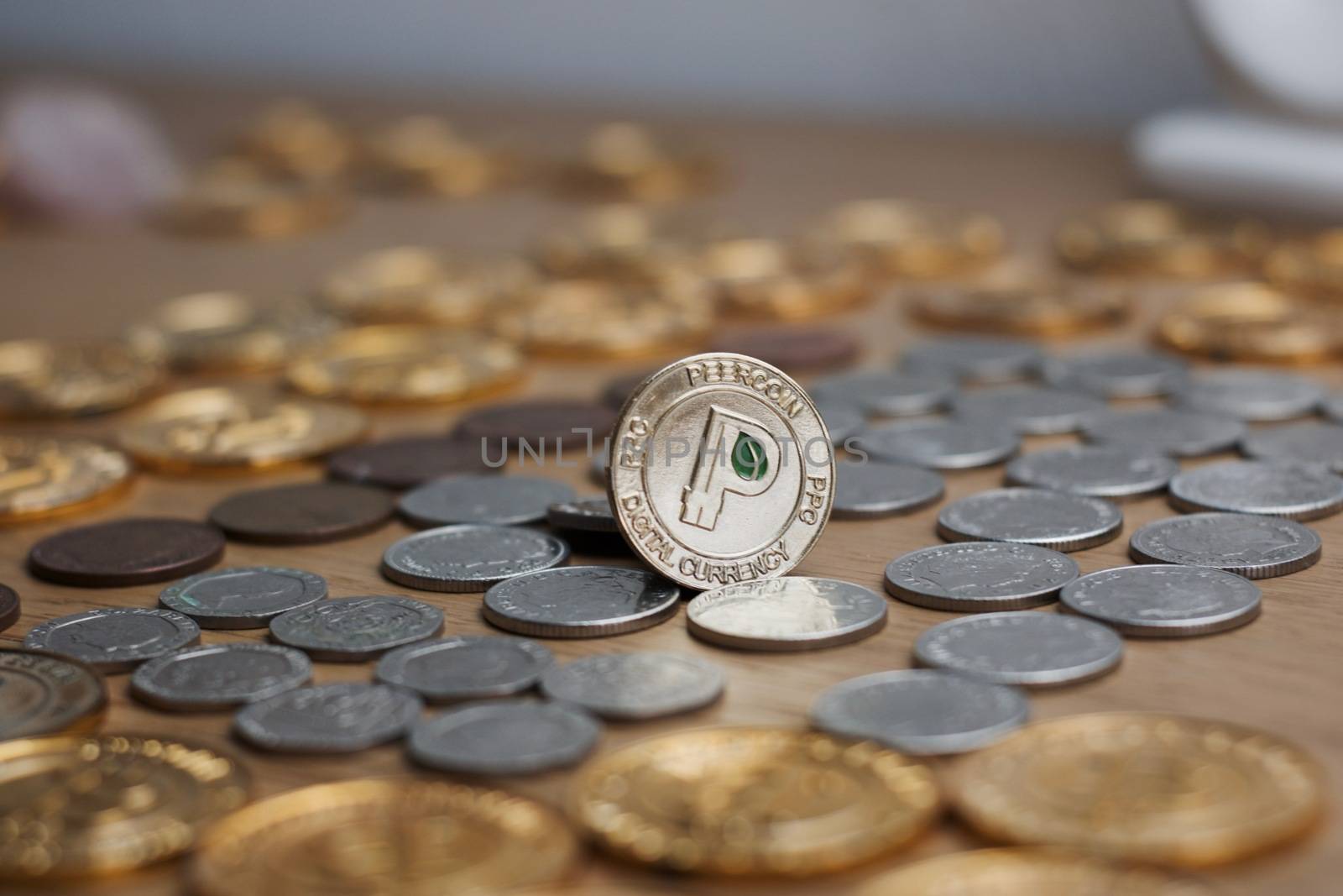Digital currency physical metal gold peercoin coin. Cryptocurrency concept.