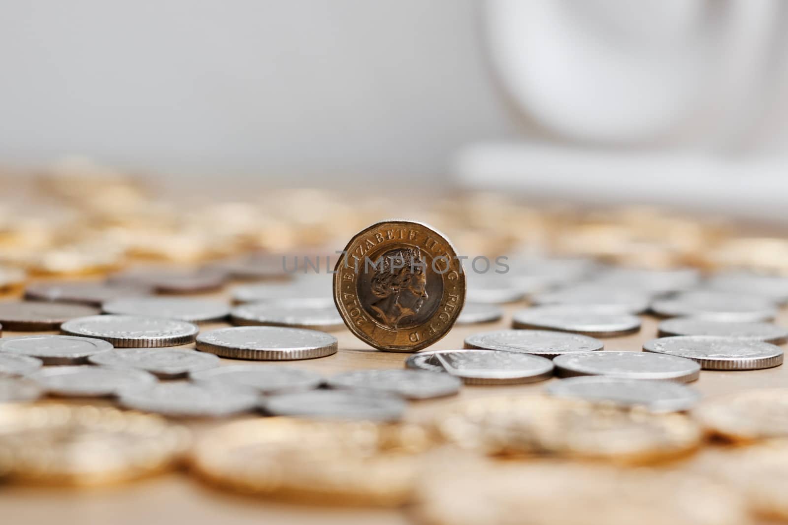 One silver and gold british pound coin. Cash from United Kingdom.