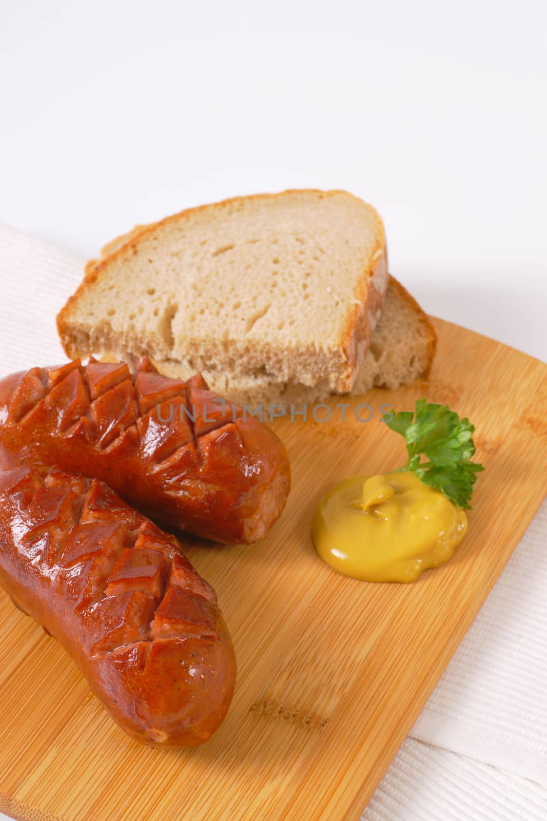 short thick sausages with bread by Digifoodstock