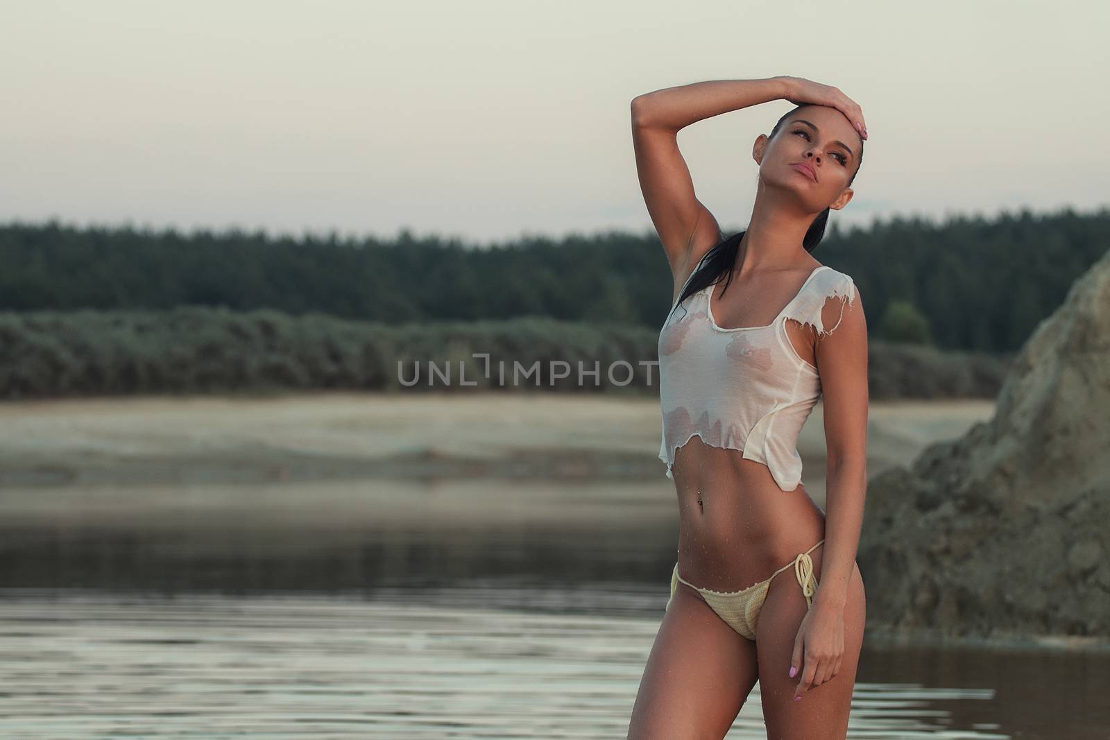 Girl in swimsuit at the sea. High fashion look.glamor beautiful sexy stylish blond. Caucasian young woman model.