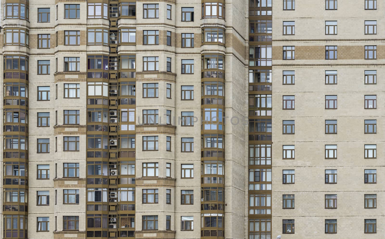 Front view of office building windows. Building of yellow brick