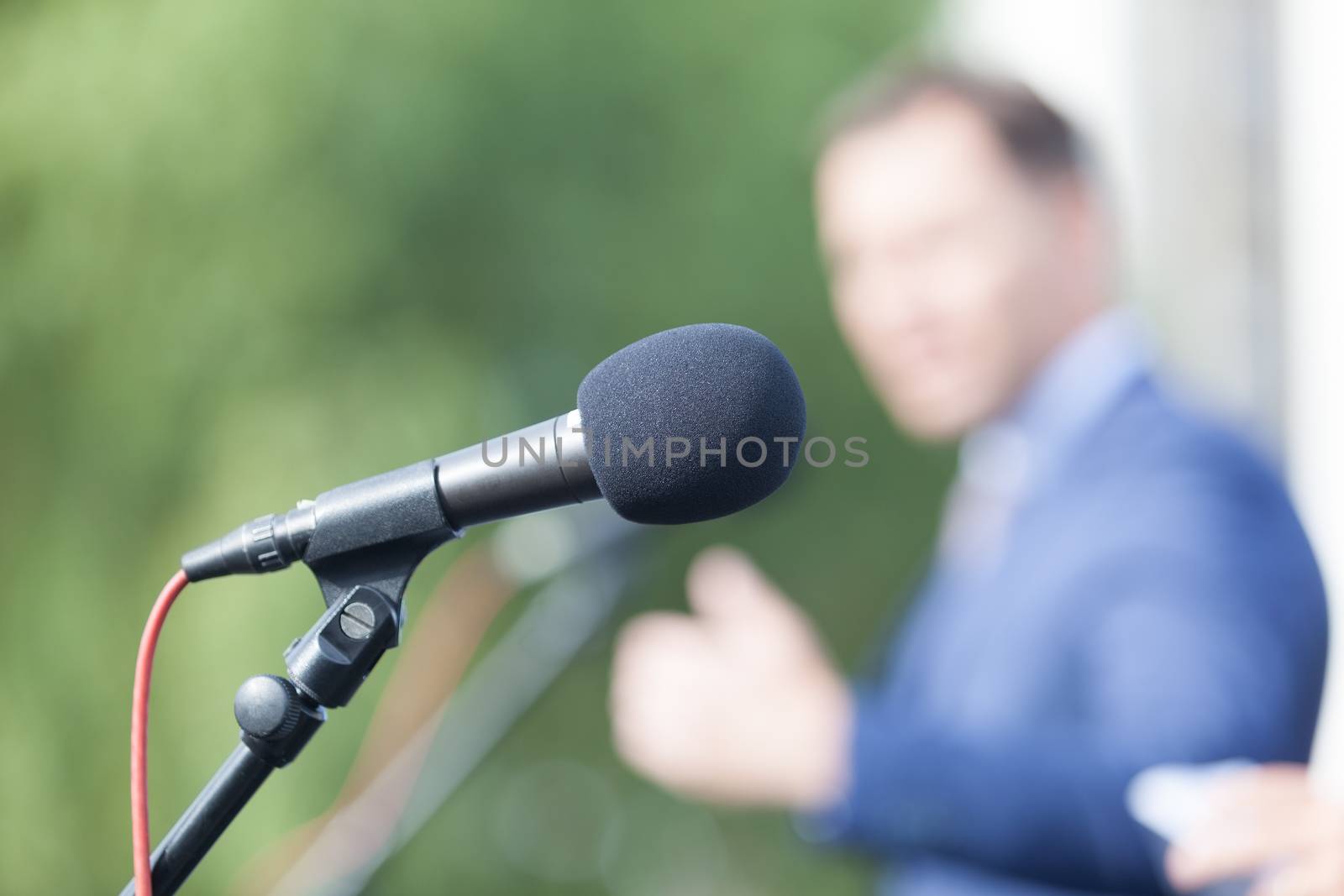 Speaker. Speech. Microphone. News conference. by wellphoto