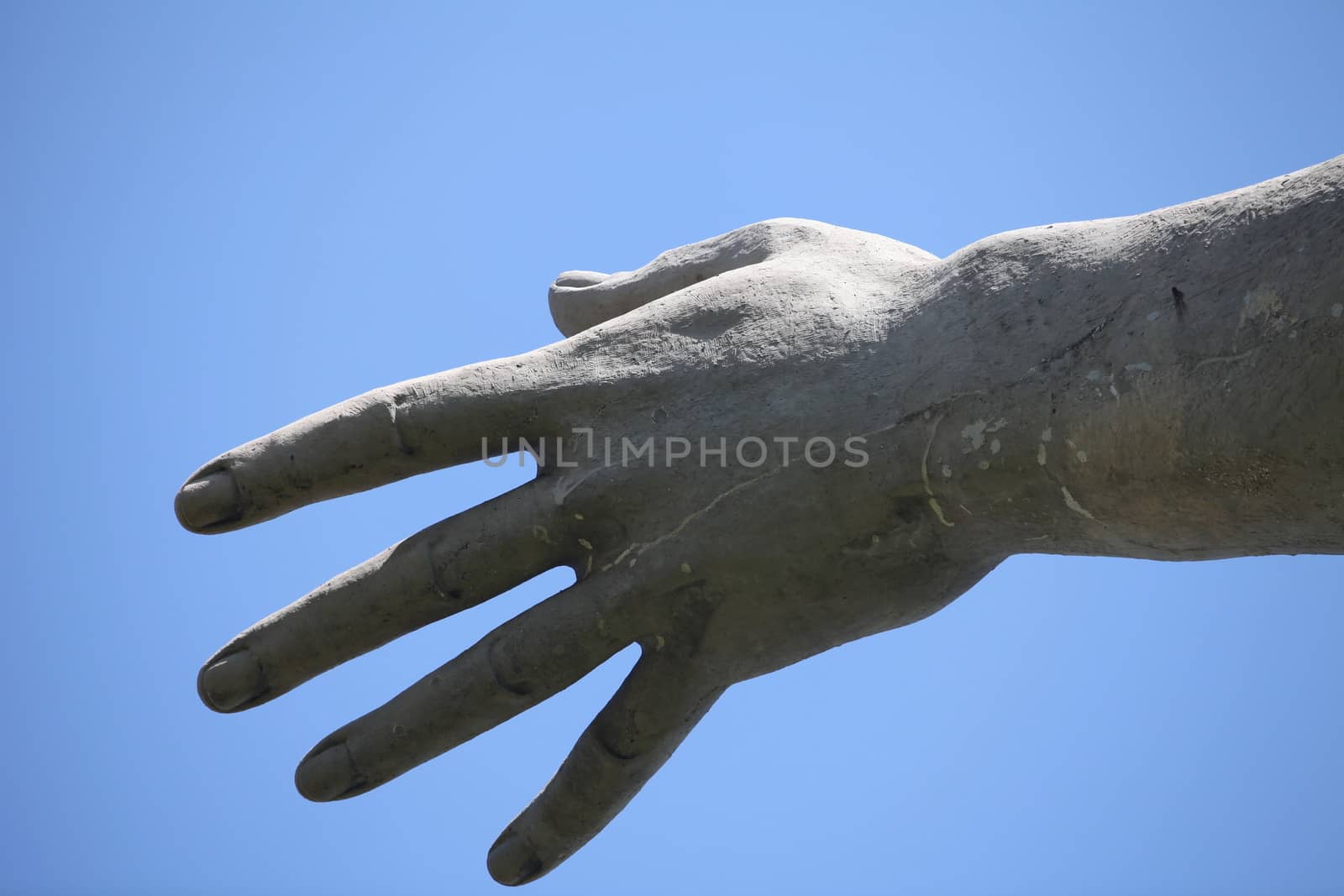 freedom stretched the hand up, against the blue sky, monument close to