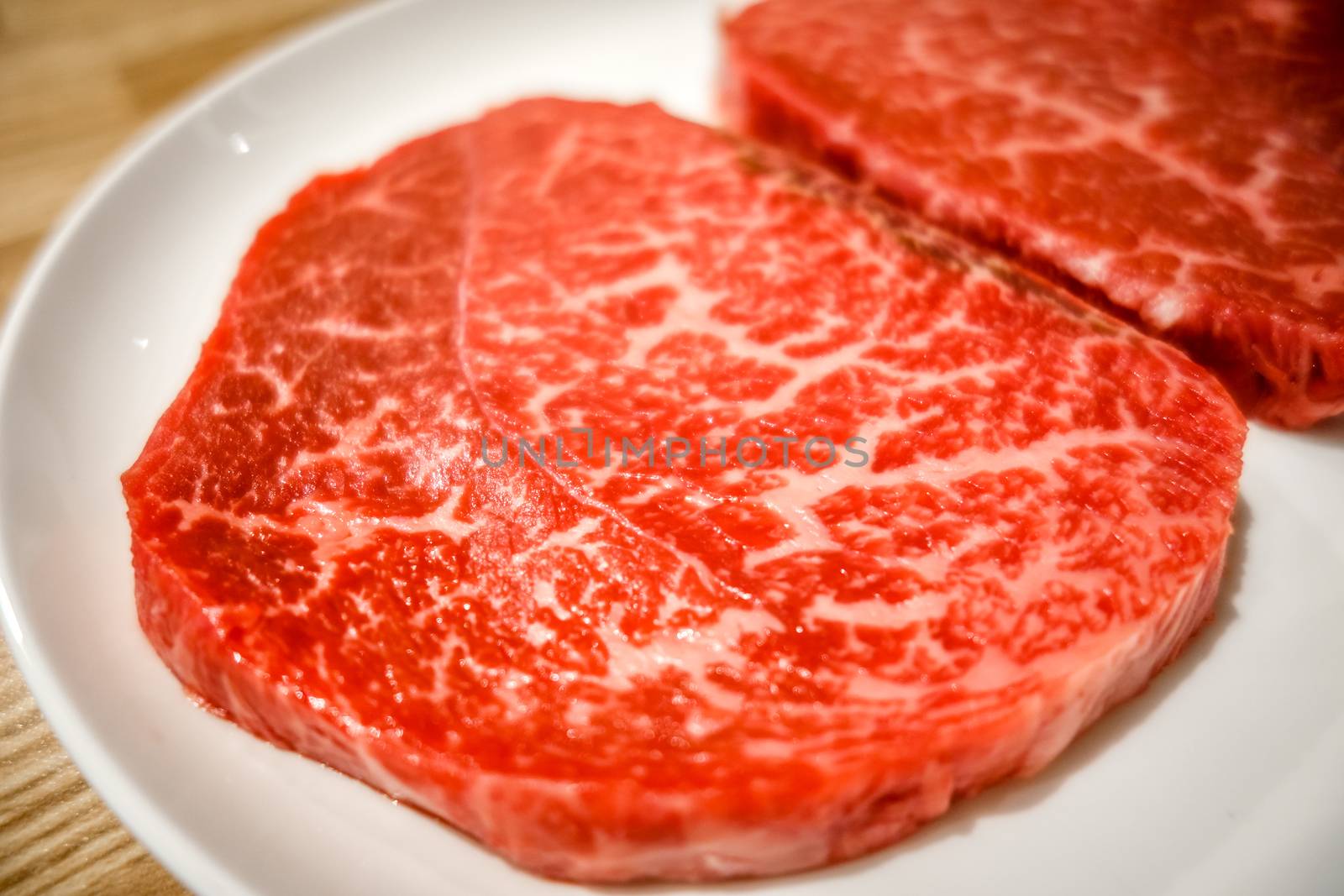 Raw Kobe wagyu beef steaks in a plate