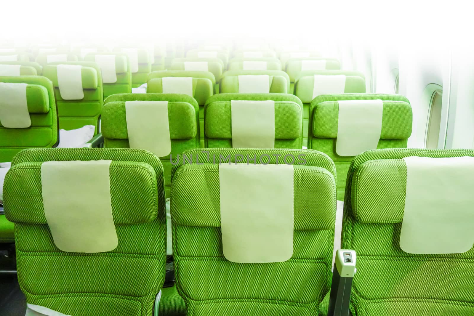 Green Airplane seats in cabin. Interior view