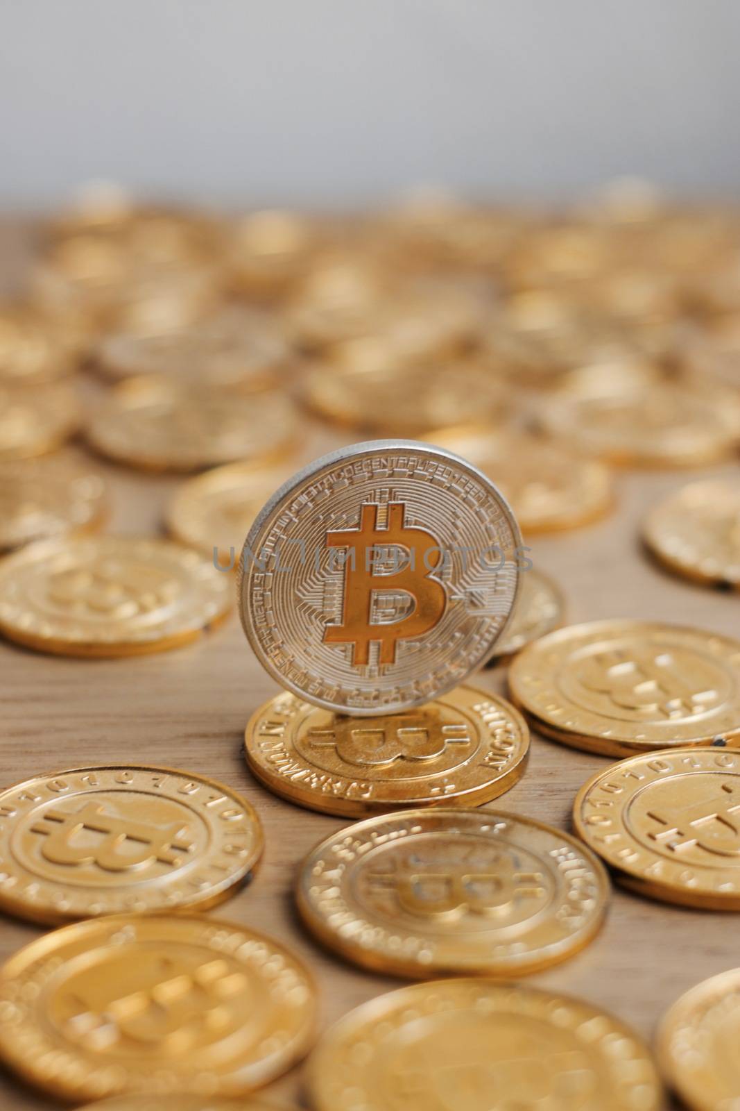 Digital currency physical bitcoin coin. Gold background coins concept.
