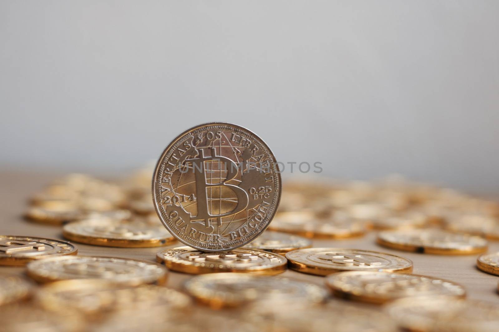 Digital currency physical bitcoin coin. Gold background coins concept.