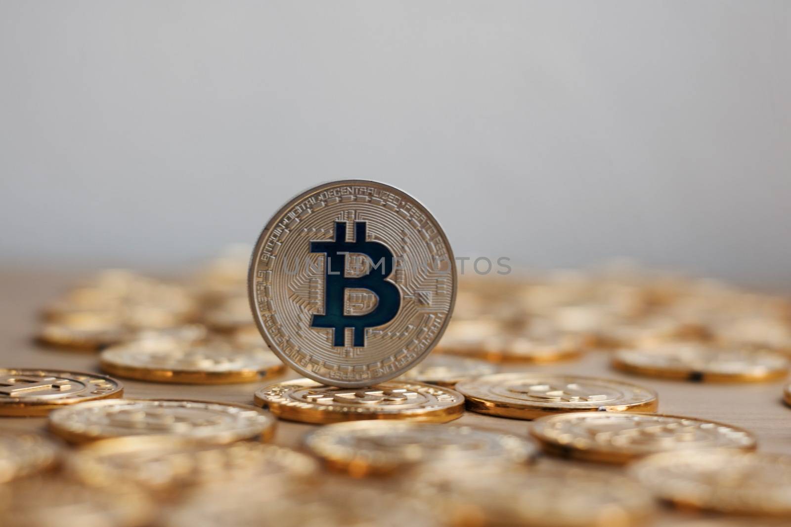 Digital currency physical bitcoin coin. Gold background coins concept.