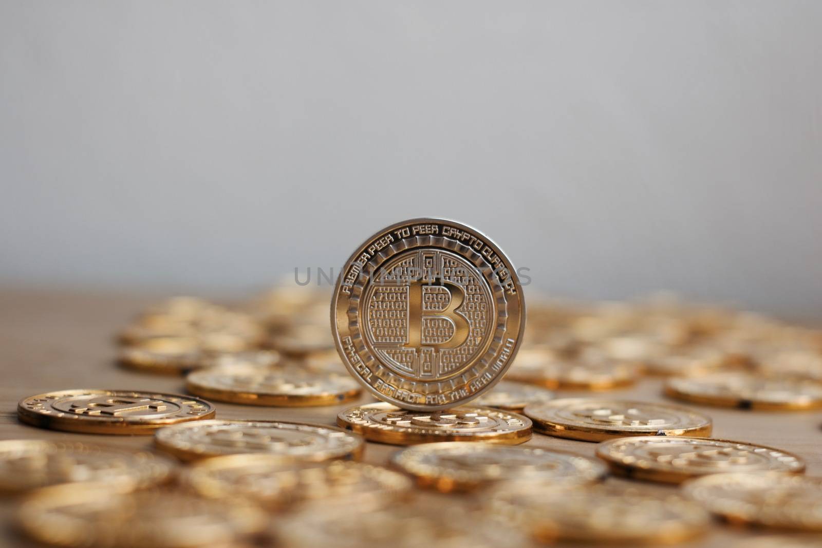 Digital currency physical bitcoin coin. Gold background coins concept.