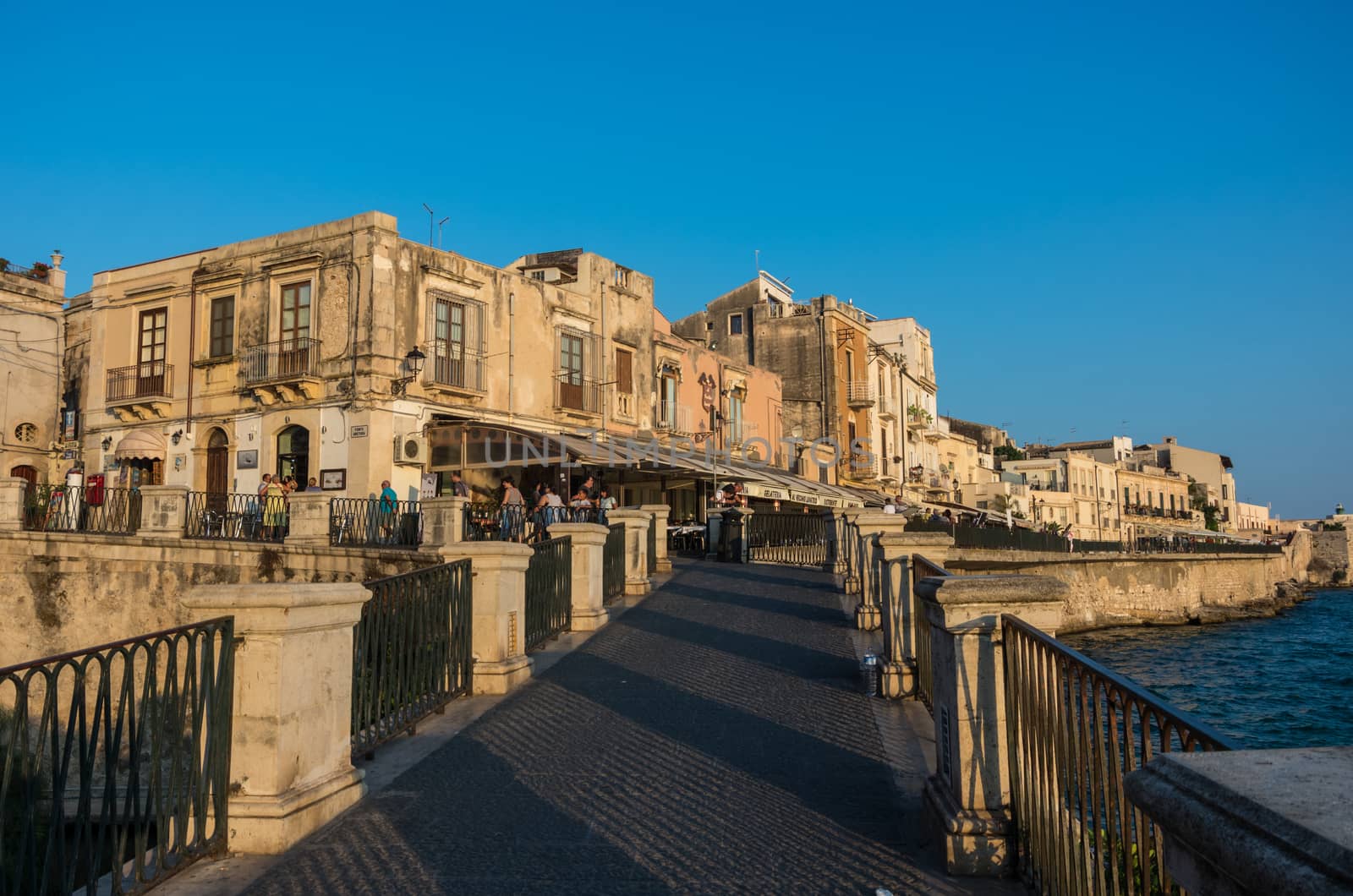 Syracuse, Italy - August 31, 2017: Sunset in Embankment of Ortygia island, Syracuse city, in Sicily.