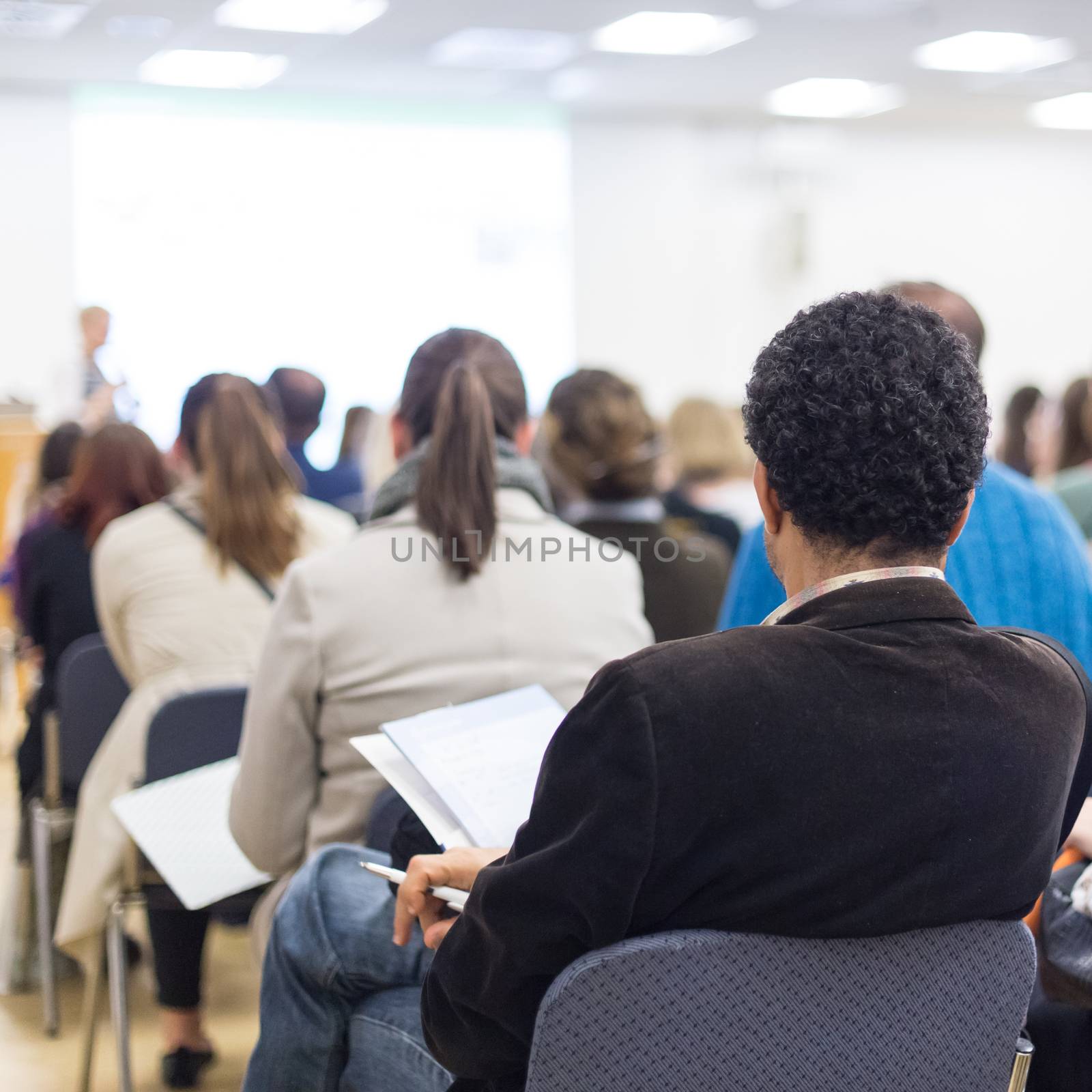 Woman giving presentation on business conference. by kasto