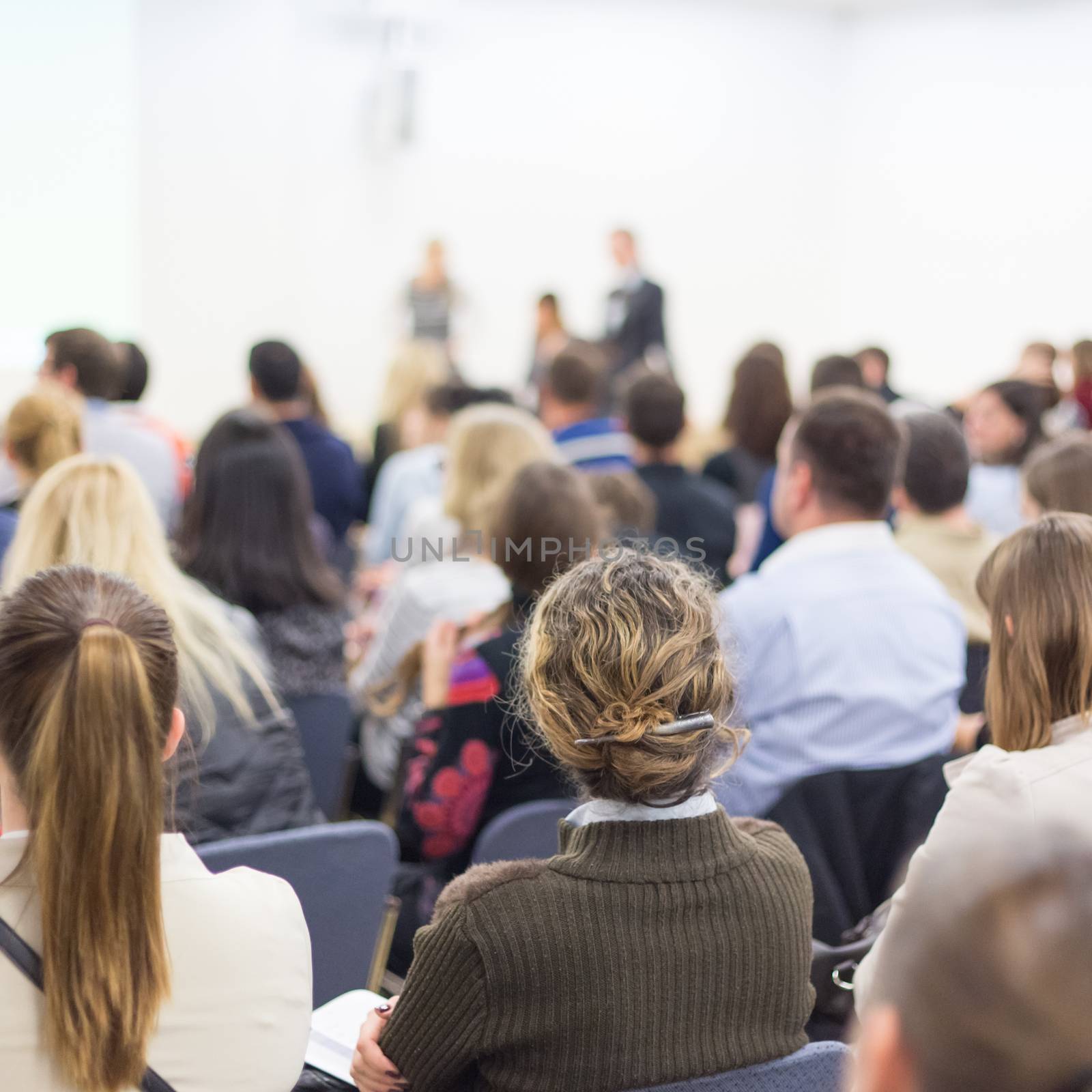 Woman giving presentation on business conference. by kasto