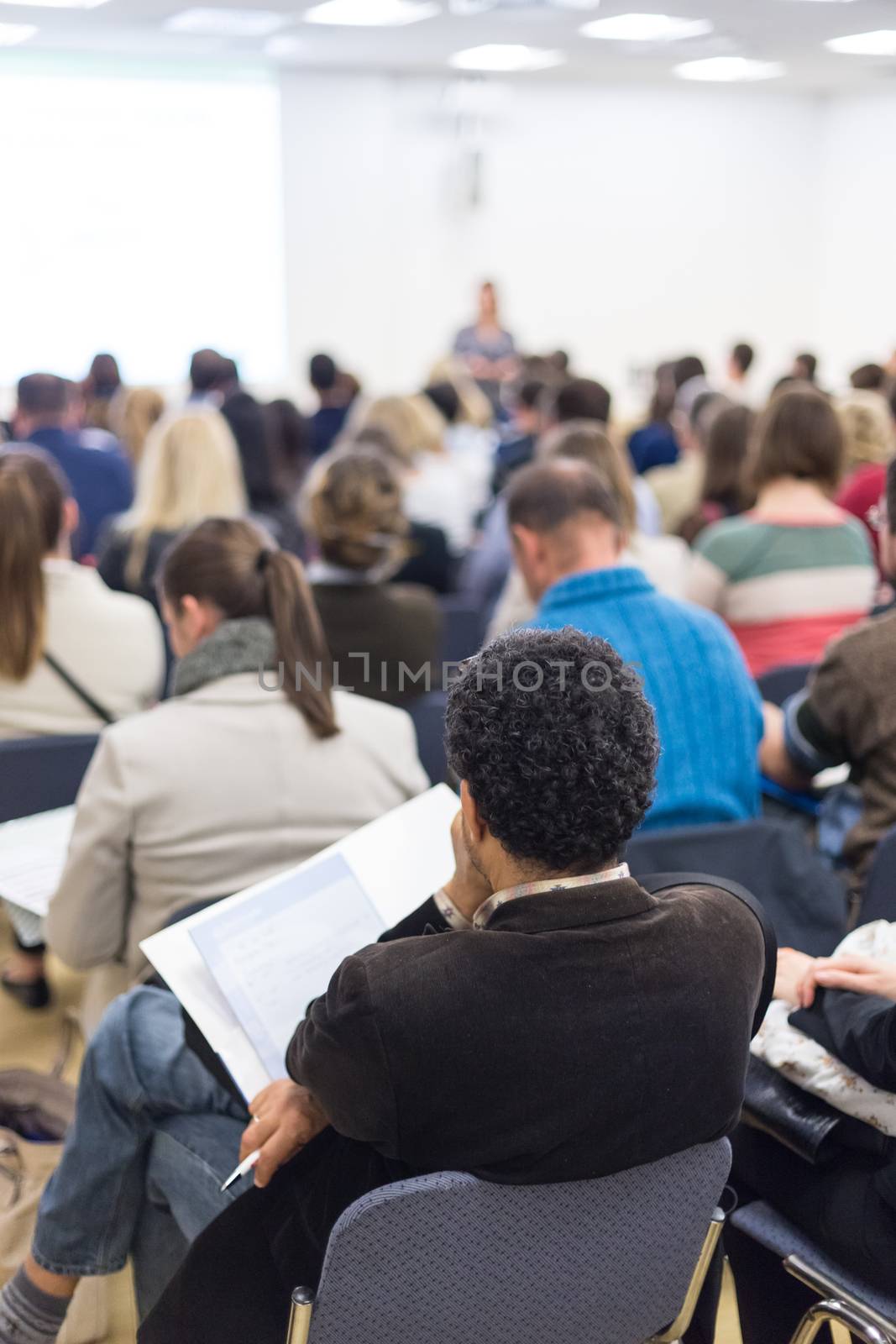 Woman giving presentation on business conference. by kasto