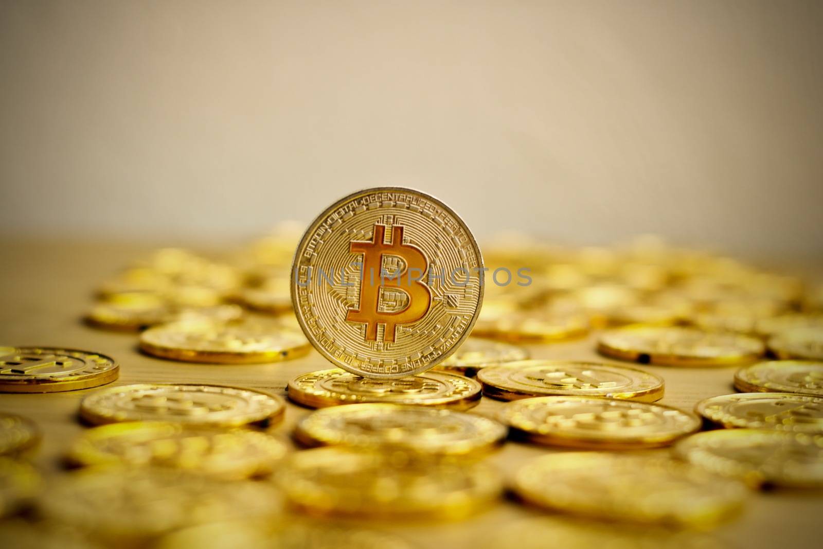 Digital currency physical bitcoin coin. Gold background coins concept.