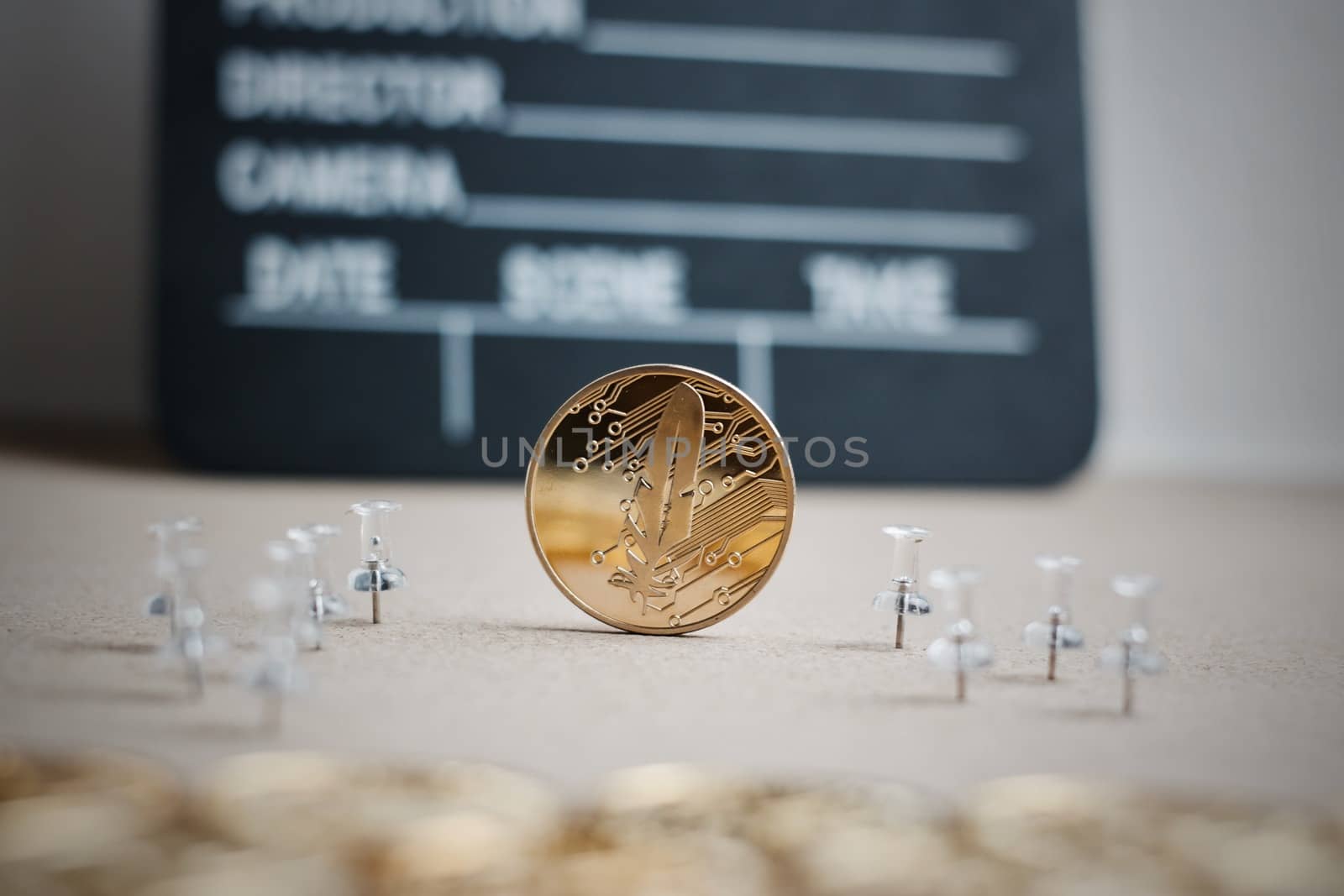 Digital currency physical gold feather coin. Cinema cryptocurrency concept.